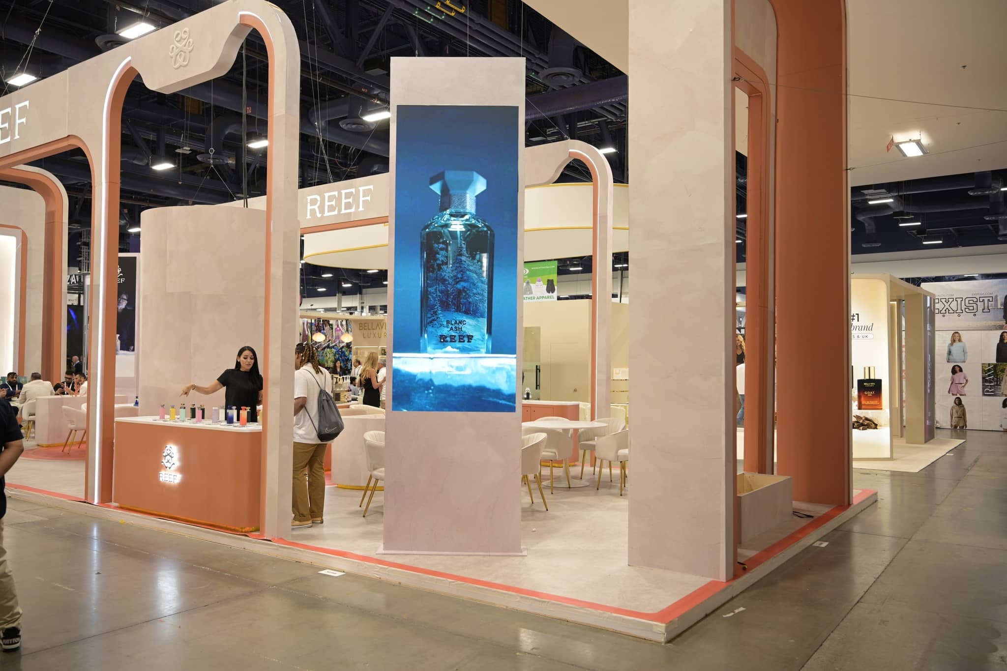 REEF fragrance booth with illuminated branding and product displays
